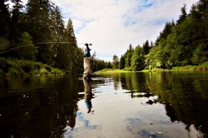 Here's a trout fly fisher out fully loading up his back cast for a long range fly presentation